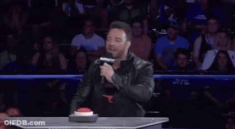 A Man Holding A Microphone With A Speech Bubble That Says " Dummy " GIF
