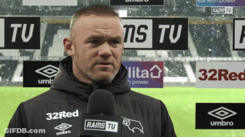 A Man Holding A Microphone With Rams Tv On It GIF