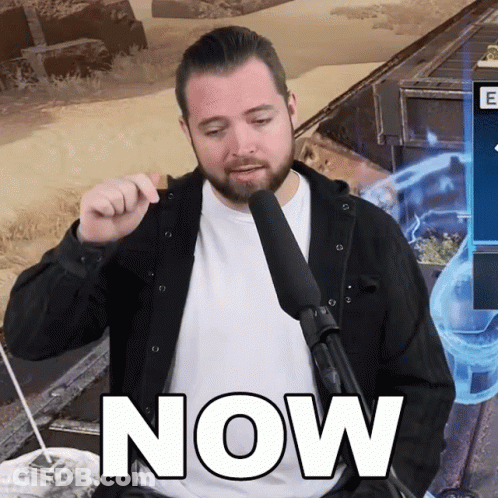 A Man Holding A Microphone With The Word Now Written On It GIF