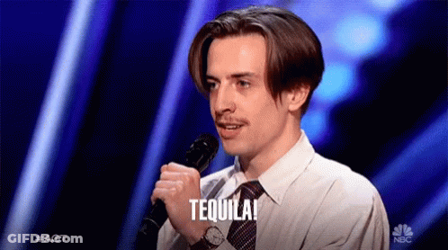 A Man Holding A Microphone With The Word Tequila Written On It GIF