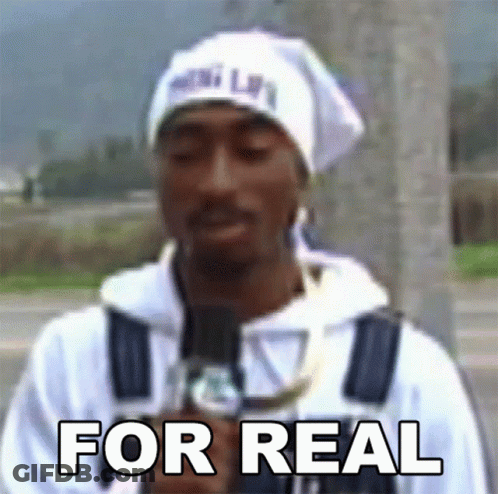 A Man Holding A Microphone With The Words For Real Written On His Chest GIF