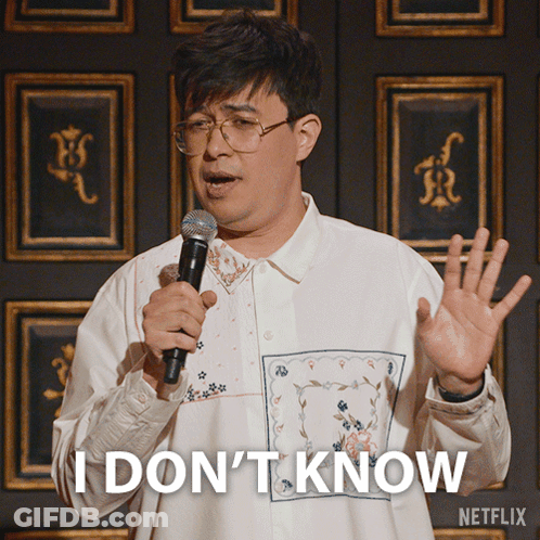 A Man Holding A Microphone With The Words I Don 'T Know On His Shirt GIF