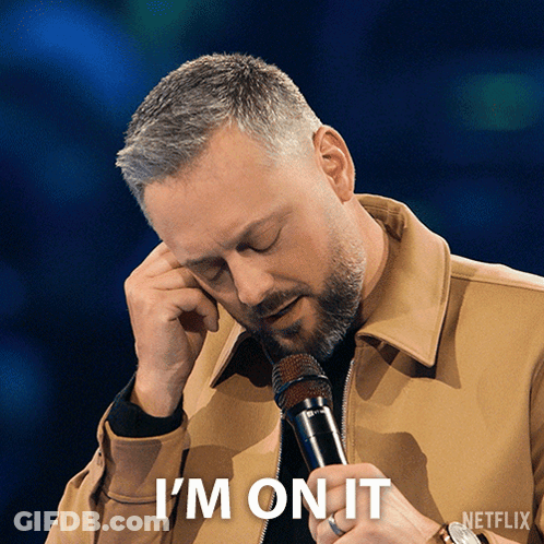 A Man Holding A Microphone With The Words " I 'M On It " Below Him GIF