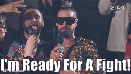 A Man Holding A Microphone With The Words I 'M Ready For A Fight Below Him GIF