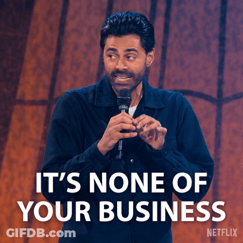 A Man Holding A Microphone With The Words It 'S None Of Your Business GIF