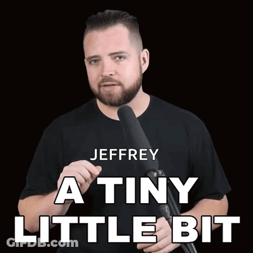 A Man Holding A Microphone With The Words Jeffrey A Tiny Little Bit Written Above Him GIF