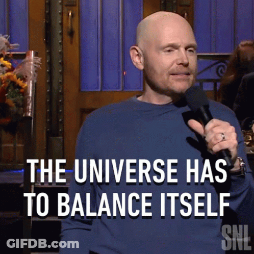 A Man Holding A Microphone With The Words " The Universe Has To Balance Itself " Behind Him GIF