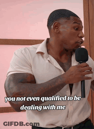 A Man Holding A Microphone With The Words " You Not Even Qualified To Be Dealing With Me " On The Bottom GIF