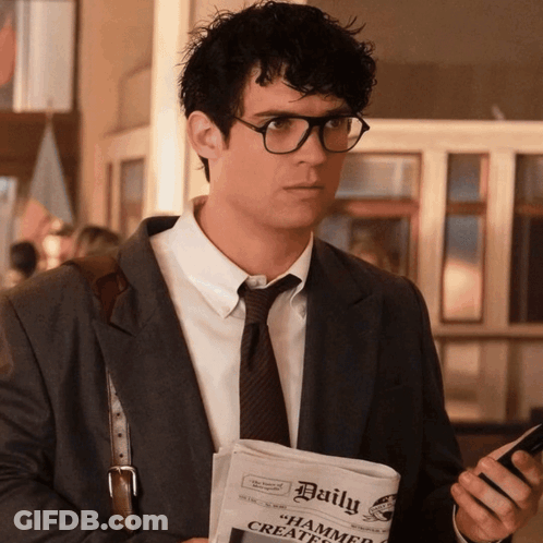 A Man Holding A Newspaper That Says Daily GIF