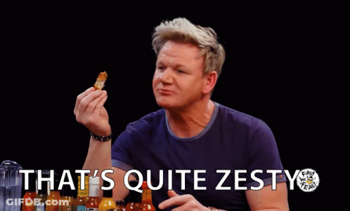 A Man Holding A Piece Of Food With The Words That 'S Quite Zesty Written Below Him GIF