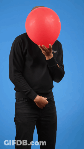A Man Holding A Red Balloon In Front Of His Face Wearing A Black Sweatshirt That Says ' Balenciaga ' On It GIF