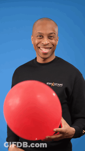 A Man Holding A Red Balloon Wearing A Black Shirt That Says Boiling Brains GIF
