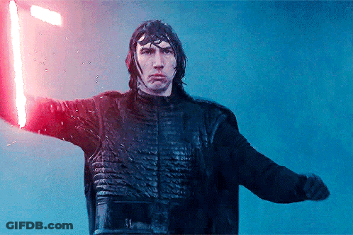A Man Holding A Red Light Saber In His Hand GIF