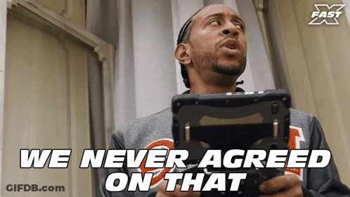 A Man Holding A Remote Control With The Words " We Never Agreed On That " Above Him GIF