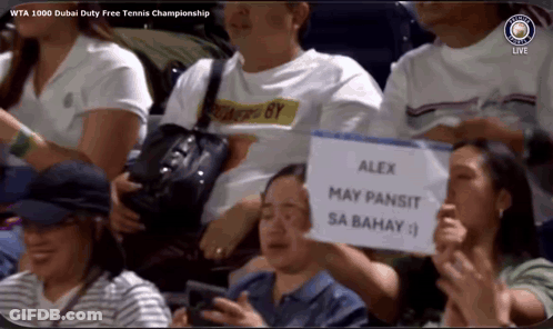 A Man Holding A Sign That Says Alex May Pansit Sa Bahay On It GIF
