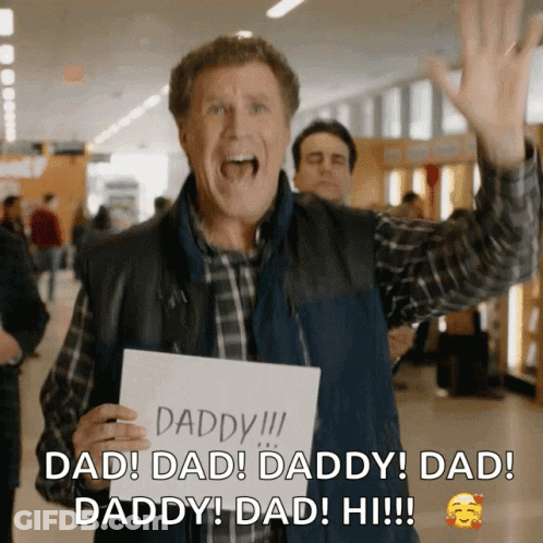 A Man Holding A Sign That Says Daddy GIF
