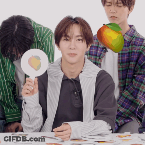 A Man Holding A Sign That Says Peach On It GIF