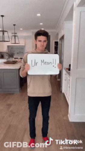 A Man Holding A Sign That Says Ur Mean On It GIF
