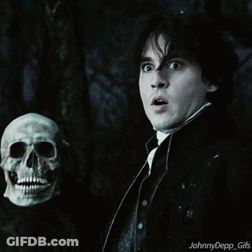 A Man Holding A Skull With A Surprised Look On His Face And The Words Johnnydepp_gifs Below Him GIF