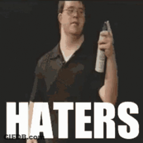 A Man Holding A Spray Can With The Word Haters In White GIF