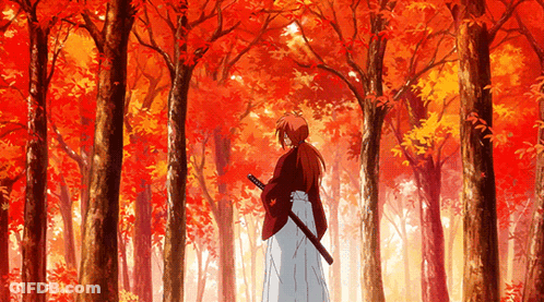 A Man Holding A Sword In A Forest With Red Leaves On The Trees GIF