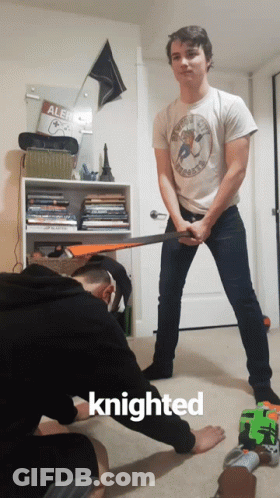 A Man Holding A Sword Next To Another Man With The Word Knighted On The Bottom GIF