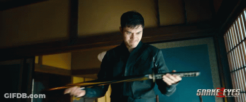 A Man Holding A Sword With Snake Eyes Written On The Bottom Right GIF