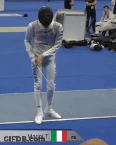 A Man Holding A Sword With The Name Marini T. GIF