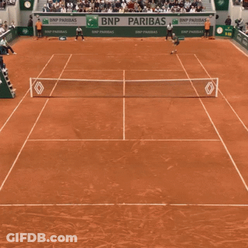 A Man Holding A Tennis Racquet In Front Of A Bnp Banner GIF