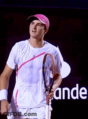 A Man Holding A Tennis Racquet In Front Of A Sign That Says " Ande " GIF