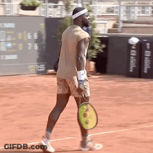 A Man Holding A Tennis Racquet On A Court GIF