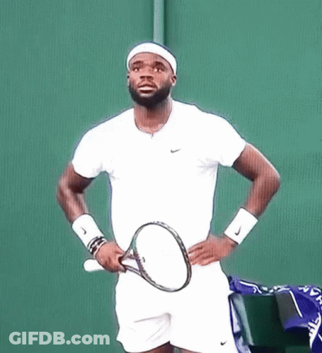 A Man Holding A Tennis Racquet On A Court GIF