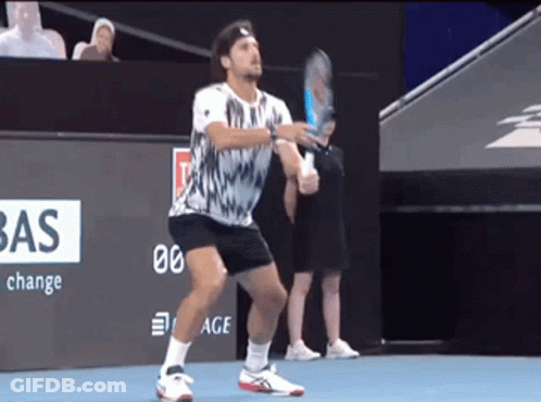 A Man Holding A Tennis Racquet On A Court With A Bas Sign In The Background GIF