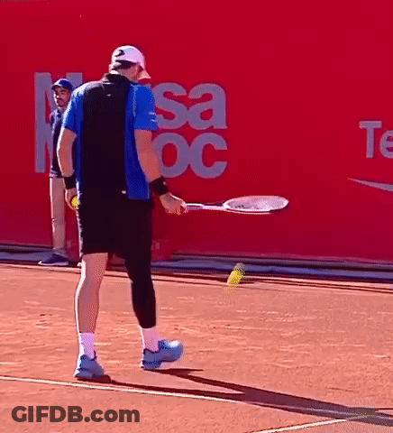 A Man Holding A Tennis Racquet On A Tennis Court In Front Of A Sign That Says Sa Oc GIF