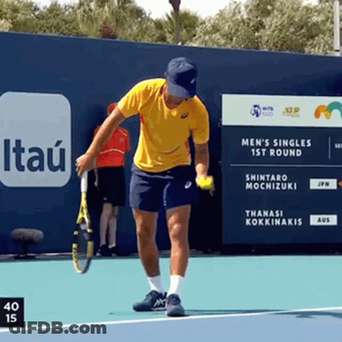 A Man Holding A Tennis Racquet On A Tennis Court With A Sign That Says Itau In The Background GIF