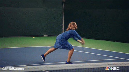 A Man Holding A Tennis Racquet On A Tennis Court With The Nbc Logo GIF