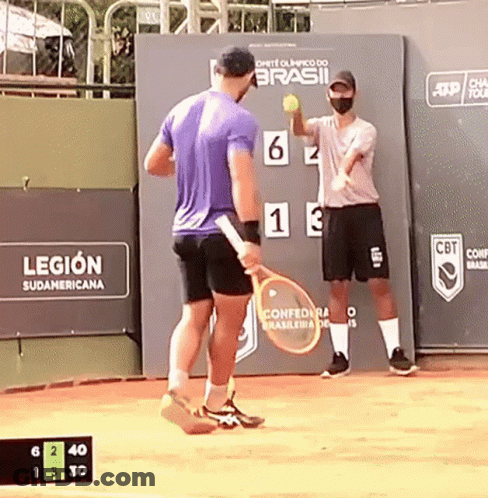 A Man Holding A Tennis Racquet Stands In Front Of A Sign That Says Legion GIF