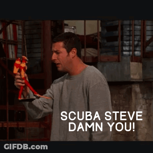 A Man Holding A Toy With The Words Scuba Steve Damn You Below Him GIF