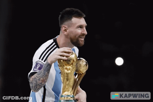 A Man Holding A Trophy That Says Kapwing On The Bottom Right GIF