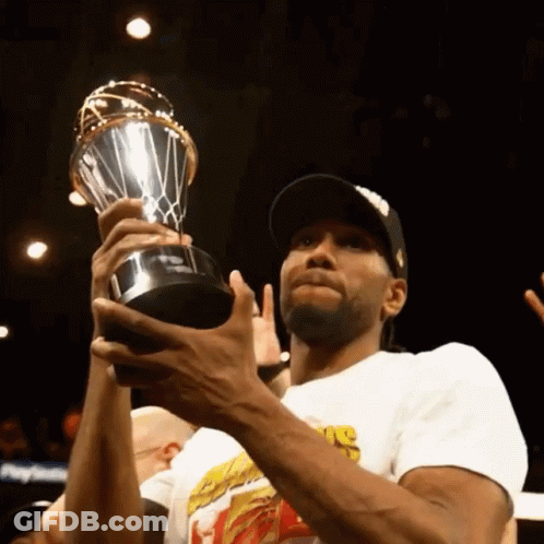 A Man Holding A Trophy That Says ' Nba ' On The Front GIF