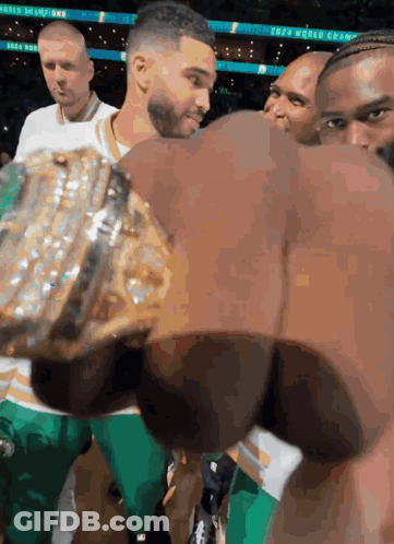 A Man Holding A Trophy That Says World Champion GIF