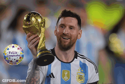 A Man Holding A Trophy With A Feliz Cumpleanos Balloon In The Background GIF