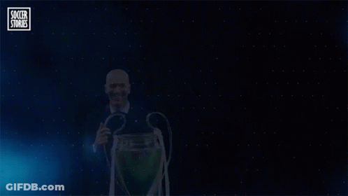 A Man Holding A Trophy With The Word Zidane On The Bottom GIF
