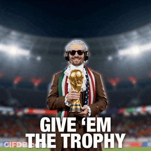 A Man Holding A Trophy With The Words Give ' Em The Trophy Below Him GIF