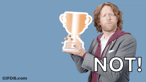 A Man Holding A Trophy With The Words " You Deserve A Trophy Not " Behind Him GIF