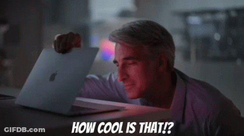 A Man Holding An Apple Laptop With The Words How Cool Is That Below Him GIF