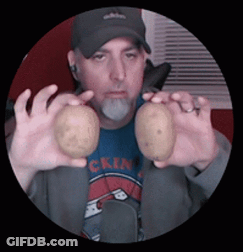 A Man Holding Two Potatoes In Front Of His Face GIF