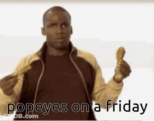 A Man Holding Up A Chicken Wing With The Words Popeyes On A Friday Written Below Him GIF
