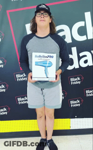 Man With Babyliss Hair Dryer In Front Of Black Friday Banner GIF