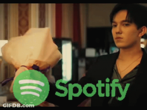 A Man Holds A Bouquet Of Flowers In Front Of A Spotify Logo GIF